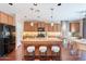 Beautiful kitchen boasts a large island, wood cabinetry, and stainless steel appliances at 2323 W Kachina Trl, Phoenix, AZ 85041