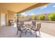 Covered patio has a dining table and chairs with a well landscaped backyard and mountain view at 2323 W Kachina Trl, Phoenix, AZ 85041