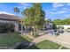 Expansive backyard with lush lawn, mature trees, patio, and a sparkling pool at 2333 E Egret Ct, Gilbert, AZ 85234