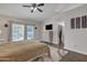 Comfortable bedroom with a ceiling fan and sliding doors leading to the backyard at 2333 E Egret Ct, Gilbert, AZ 85234
