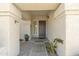 Welcoming front entrance with a decorative door, framed by elegant columns and plants at 2333 E Egret Ct, Gilbert, AZ 85234