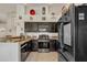 Galley kitchen with dark wood cabinetry, stainless steel appliances, and a convenient layout at 2333 E Egret Ct, Gilbert, AZ 85234