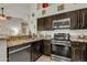 Kitchen with stainless steel appliances and dark wood cabinets that add to the home's value at 2333 E Egret Ct, Gilbert, AZ 85234