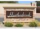 Welcome to Heatherbrook: A community entrance sign with a stone base surrounded by flowers at 2369 W Shawnee Dr, Chandler, AZ 85224