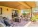 Inviting covered patio with a fire pit, comfortable seating, and a view through sliding glass doors to the interior at 2369 W Shawnee Dr, Chandler, AZ 85224