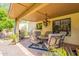 Covered patio with a dining table, grill, and comfortable seating, ideal for outdoor entertaining and relaxation at 2369 W Shawnee Dr, Chandler, AZ 85224