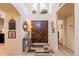 Bright foyer with high ceilings, dark wood front door, decorative console table and rug at 2369 W Shawnee Dr, Chandler, AZ 85224