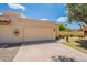 Beige single-Gathering home with a two-car garage, desert landscaping, and lovely curb appeal at 2369 W Shawnee Dr, Chandler, AZ 85224