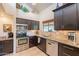 Well-equipped kitchen featuring stainless steel appliances, granite countertops, and dark wood cabinets at 2369 W Shawnee Dr, Chandler, AZ 85224