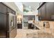 Bright kitchen with stainless appliances, granite counters, dark cabinets, and vaulted ceilings at 2369 W Shawnee Dr, Chandler, AZ 85224