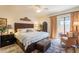 Comfortable bedroom featuring neutral tones, a ceiling fan, and access to the outdoor patio at 2369 W Shawnee Dr, Chandler, AZ 85224