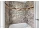 Bathroom featuring stylish tile work around a soaking tub with a shower fixture at 2633 S El Dorado Dr, Mesa, AZ 85202