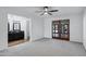 This bedroom features a ceiling fan, neutral walls, plush carpet, access to a bathroom and outdoor access at 2633 S El Dorado Dr, Mesa, AZ 85202