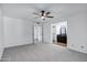 This bedroom offers a ceiling fan, neutral walls, plush carpet and has access to a bathroom and another room at 2633 S El Dorado Dr, Mesa, AZ 85202