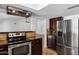 Open kitchen with stainless steel oven, tile backsplash, dark cabinets, and a stainless steel fridge at 2633 S El Dorado Dr, Mesa, AZ 85202