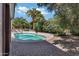 Backyard pool area surrounded by mature landscaping and a brick patio perfect for entertaining at 2633 S El Dorado Dr, Mesa, AZ 85202