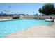 Large community pool with clear blue water, surrounded by lounge chairs and shaded areas at 2633 S El Dorado Dr, Mesa, AZ 85202