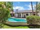 Inviting backyard pool area with lush landscaping and a covered patio, perfect for relaxation and entertaining at 2633 S El Dorado Dr, Mesa, AZ 85202