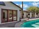 Inviting backyard pool area accessible through wood frame double doors on house at 2633 S El Dorado Dr, Mesa, AZ 85202