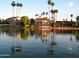 Lovely waterfront homes with lush landscaping and palm trees reflected in the calm water at 2633 S El Dorado Dr, Mesa, AZ 85202