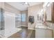 Bright bathroom with double sinks, granite countertops, and a walk-in shower at 26814 N 65Th Dr, Phoenix, AZ 85083