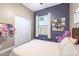 Cozy bedroom with a wood accent wall, plush carpet, and storage space at 26814 N 65Th Dr, Phoenix, AZ 85083