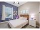 Charming bedroom with a wood accent wall, decorative art, and a comfortable bed at 26814 N 65Th Dr, Phoenix, AZ 85083