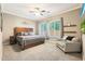 Comfortable bedroom featuring a ceiling fan, wood bed frame, and large window at 26814 N 65Th Dr, Phoenix, AZ 85083