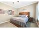 Cozy bedroom featuring a wood bed frame and neutral wall decor at 26814 N 65Th Dr, Phoenix, AZ 85083
