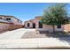 Exterior shot of house, driveway, desert rock landscaping, and mature tree at 26814 N 65Th Dr, Phoenix, AZ 85083