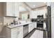 Bright kitchen with white cabinetry, stainless steel appliances, and modern finishes at 26814 N 65Th Dr, Phoenix, AZ 85083