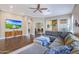 Spacious living room featuring a comfortable sectional sofa, media cabinet, and wood-look flooring at 26814 N 65Th Dr, Phoenix, AZ 85083