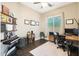 Well-lit home office with a desk, shelving, and a window providing natural light at 26814 N 65Th Dr, Phoenix, AZ 85083