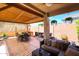 Charming covered patio with dining set, comfortable seating, grill, and a well-maintained backyard at 26814 N 65Th Dr, Phoenix, AZ 85083