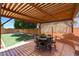 Inviting covered patio with a dining set and a view of the backyard's lush lawn at 26814 N 65Th Dr, Phoenix, AZ 85083