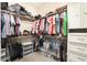Organized walk-in closet with built-in shelving, hanging racks, and ample storage space for clothes and shoes at 26814 N 65Th Dr, Phoenix, AZ 85083