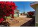 Spacious backyard featuring a partially bricked yard, a deck, and vibrant bougainvillea, perfect for outdoor relaxation at 2926 W San Miguel Ave, Phoenix, AZ 85017