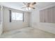 Bedroom features a window for natural light and a ceiling fan at 2926 W San Miguel Ave, Phoenix, AZ 85017