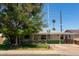 Quaint single-story home with a well-maintained front yard and mature trees, a cozy covered porch at 2926 W San Miguel Ave, Phoenix, AZ 85017