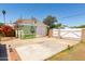 The detached garage features a wide driveway, solar panels, and colorful bougainvillea, enhancing the property's appeal at 2926 W San Miguel Ave, Phoenix, AZ 85017