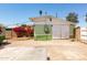 View of the detached garage with a wide driveway and colorful bougainvillea, adding curb appeal to the property at 2926 W San Miguel Ave, Phoenix, AZ 85017