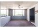 Bright living room features a ceiling fan, large windows, and neutral colors at 2926 W San Miguel Ave, Phoenix, AZ 85017