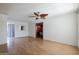 Spacious living room with hardwood floors and a decorative ceiling fan, ready for personalization at 2926 W San Miguel Ave, Phoenix, AZ 85017