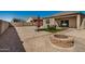 Gravel-covered backyard featuring a fire pit, outdoor seating, and manicured turf at 30238 N Ocotillo Dr, Florence, AZ 85132