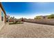 Expansive backyard featuring gravel, seating, a firepit, and views of the neighborhood at 30238 N Ocotillo Dr, Florence, AZ 85132