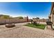 Well-maintained backyard with gravel landscaping, a built-in grill, and outdoor seating at 30238 N Ocotillo Dr, Florence, AZ 85132