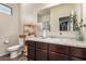Clean and functional bathroom featuring dark wood cabinets, granite countertop, and soft lighting at 30238 N Ocotillo Dr, Florence, AZ 85132