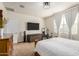 Cozy bedroom featuring carpet floors, a large window with curtains, and comfortable furnishings at 30238 N Ocotillo Dr, Florence, AZ 85132