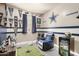 Sports-themed bedroom with a comfortable recliner, mini-fridge and themed decor at 30238 N Ocotillo Dr, Florence, AZ 85132