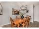 Charming dining room with a rustic wooden table, seating for six, and a decorative lighting fixture at 30238 N Ocotillo Dr, Florence, AZ 85132